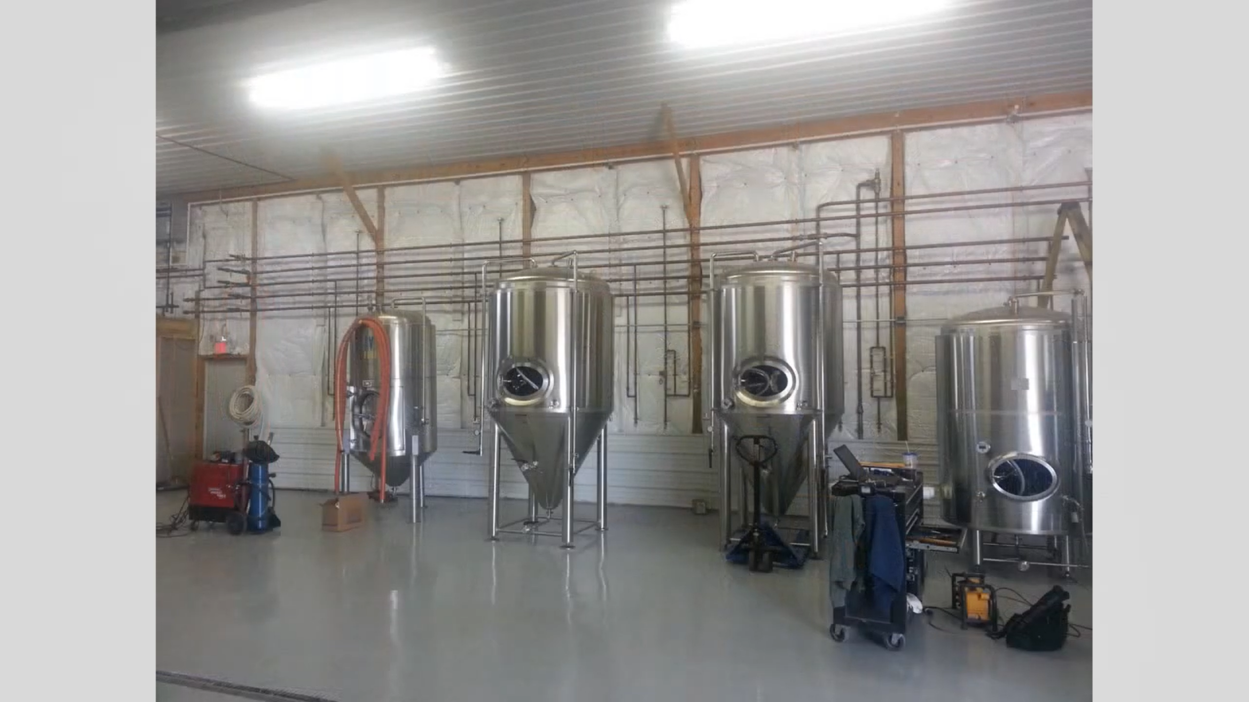 Wide brewery process piping and tank area