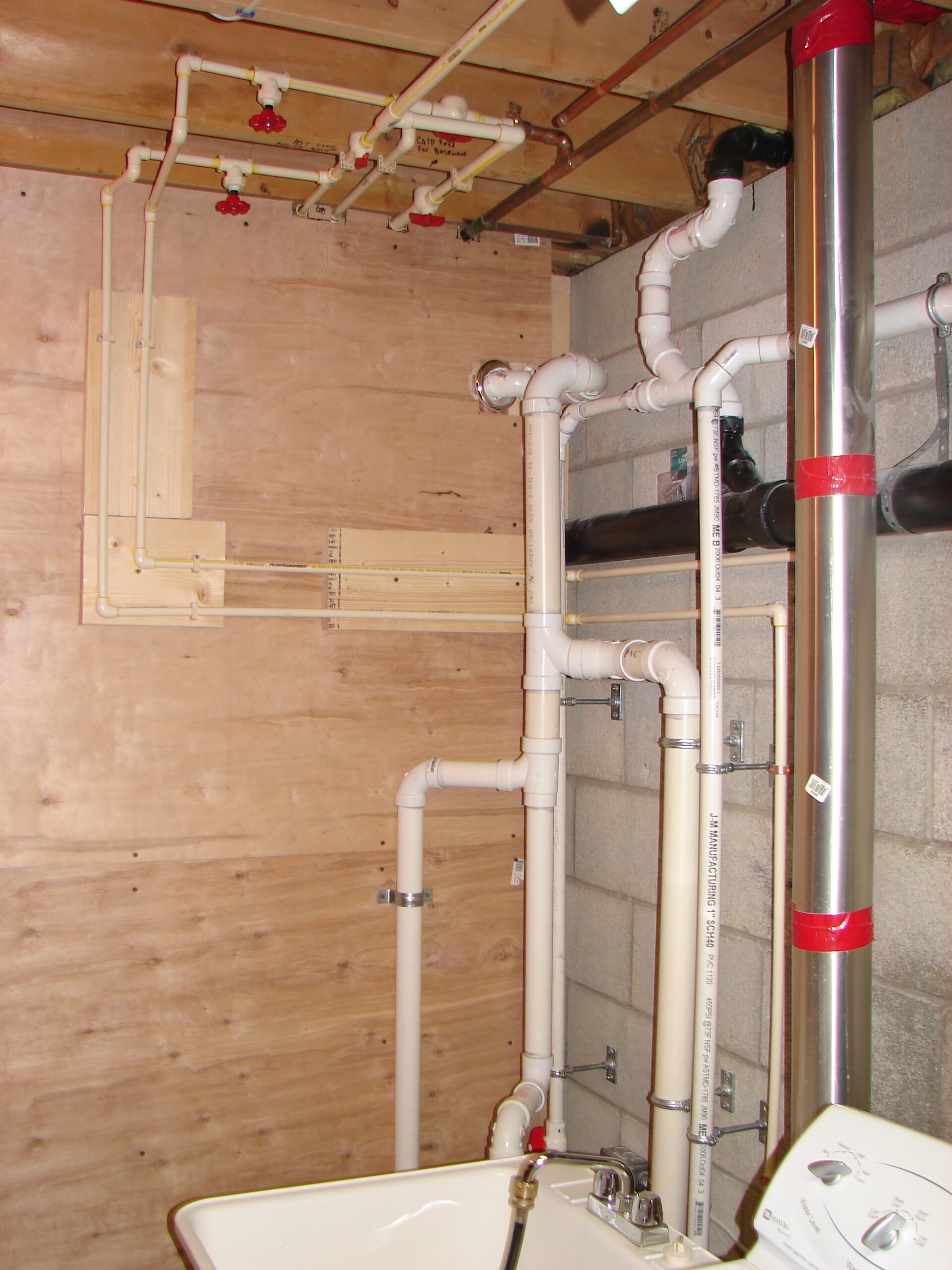 Residential project plumbing rough-in and piping support before finished surfaces